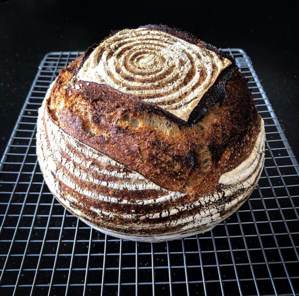 large bread loaf on cooling rack by bread ahead