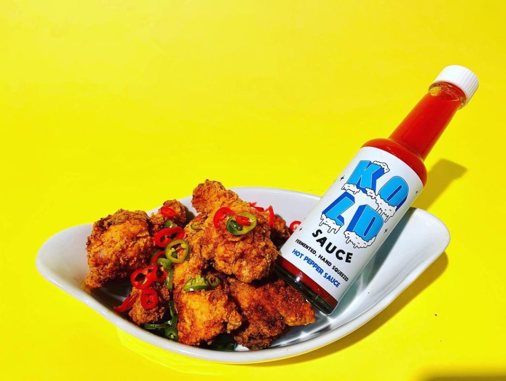Bottle of Kold Sauce with chicken wings