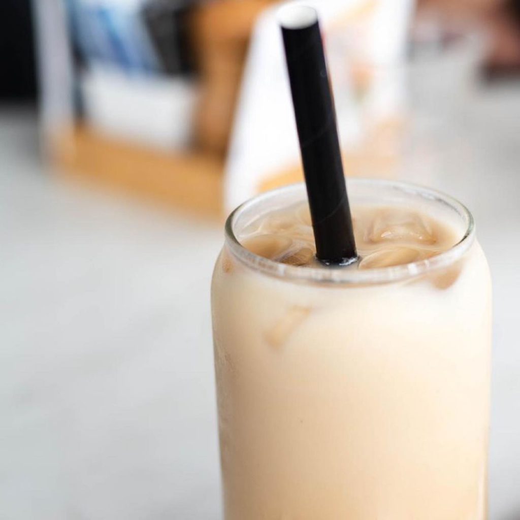 Iced chai latte with straw from UK business Chai Blue